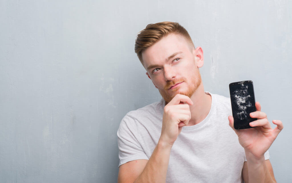 man wondering where to sell cracked iPhone online for cash